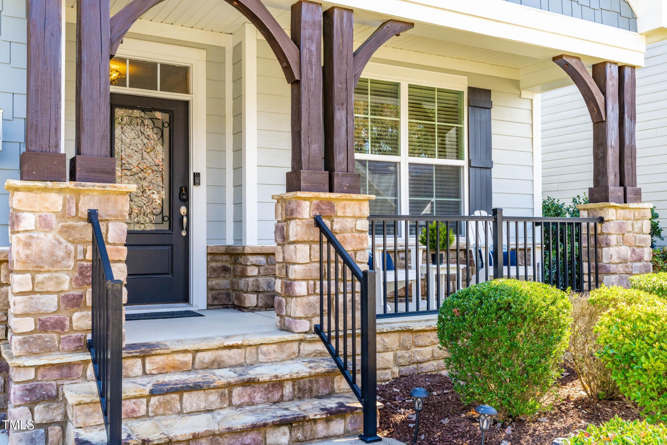 1805 Bodwin Lane Apex, NC 27502 - Photo 2 of 43 a view of a porch with a floor to ceiling window and wooden fence