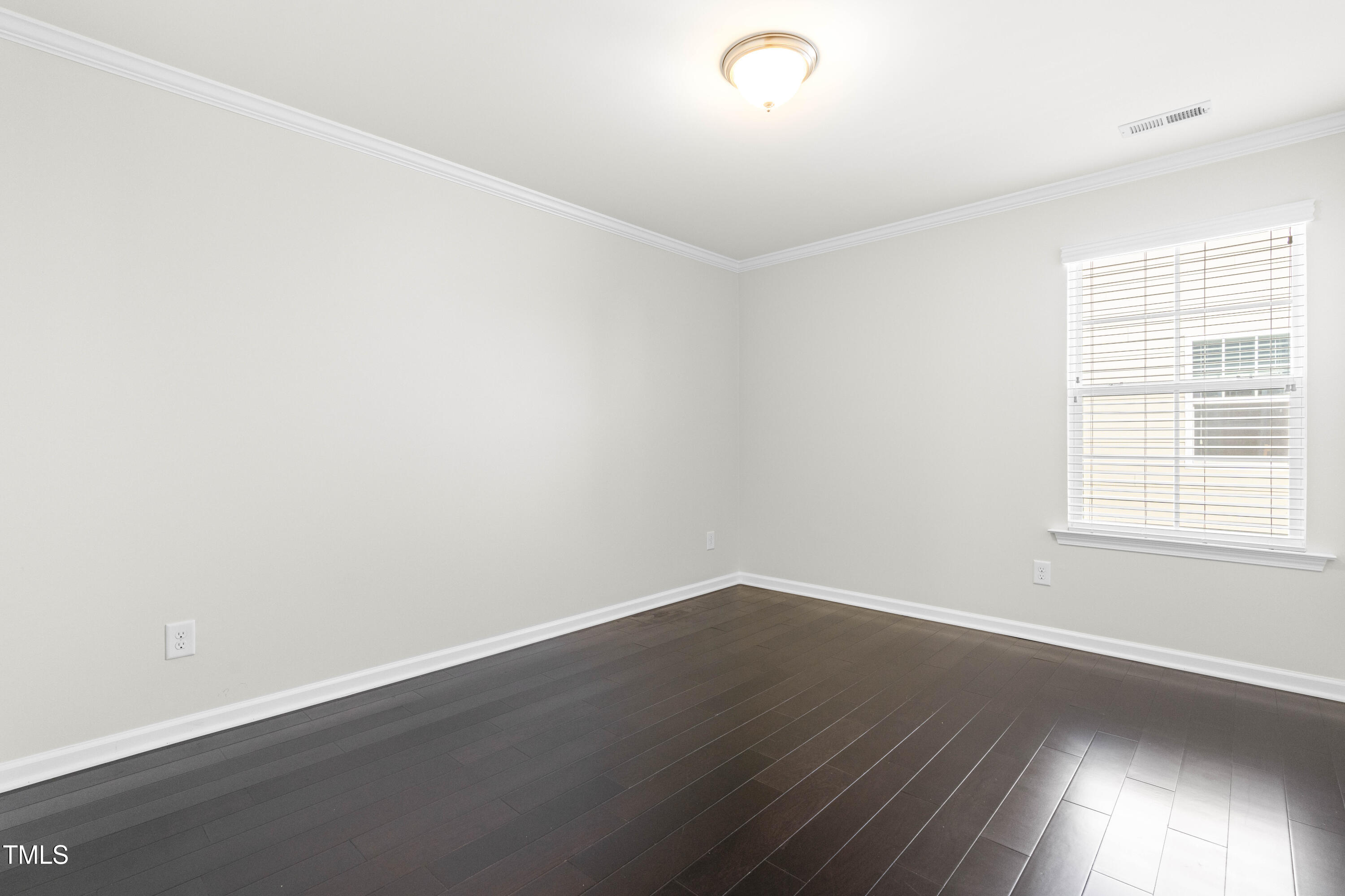 1805 Bodwin Lane Apex, NC 27502 - Photo 23 of 43 an empty room with wooden floor and windows