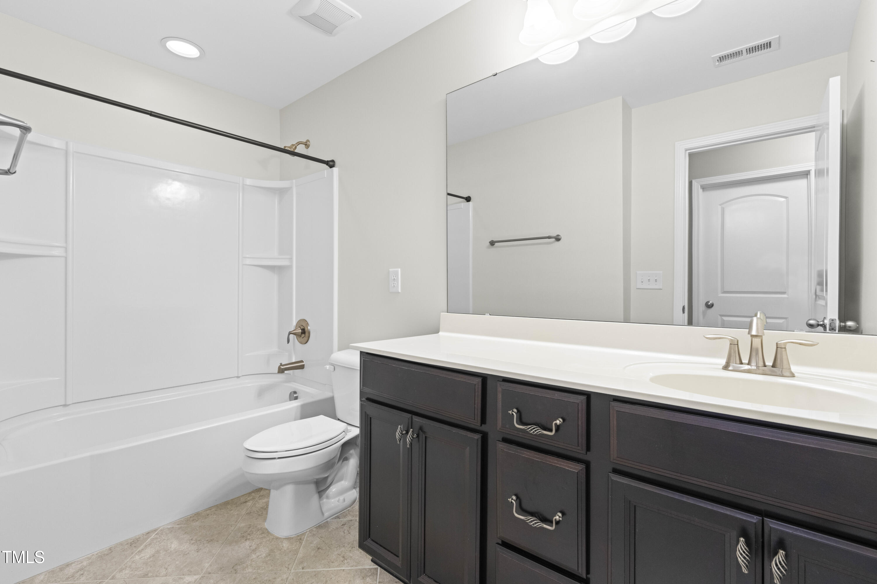 1805 Bodwin Lane Apex, NC 27502 - Photo 24 of 43 a bathroom with a sink a toilet and shower