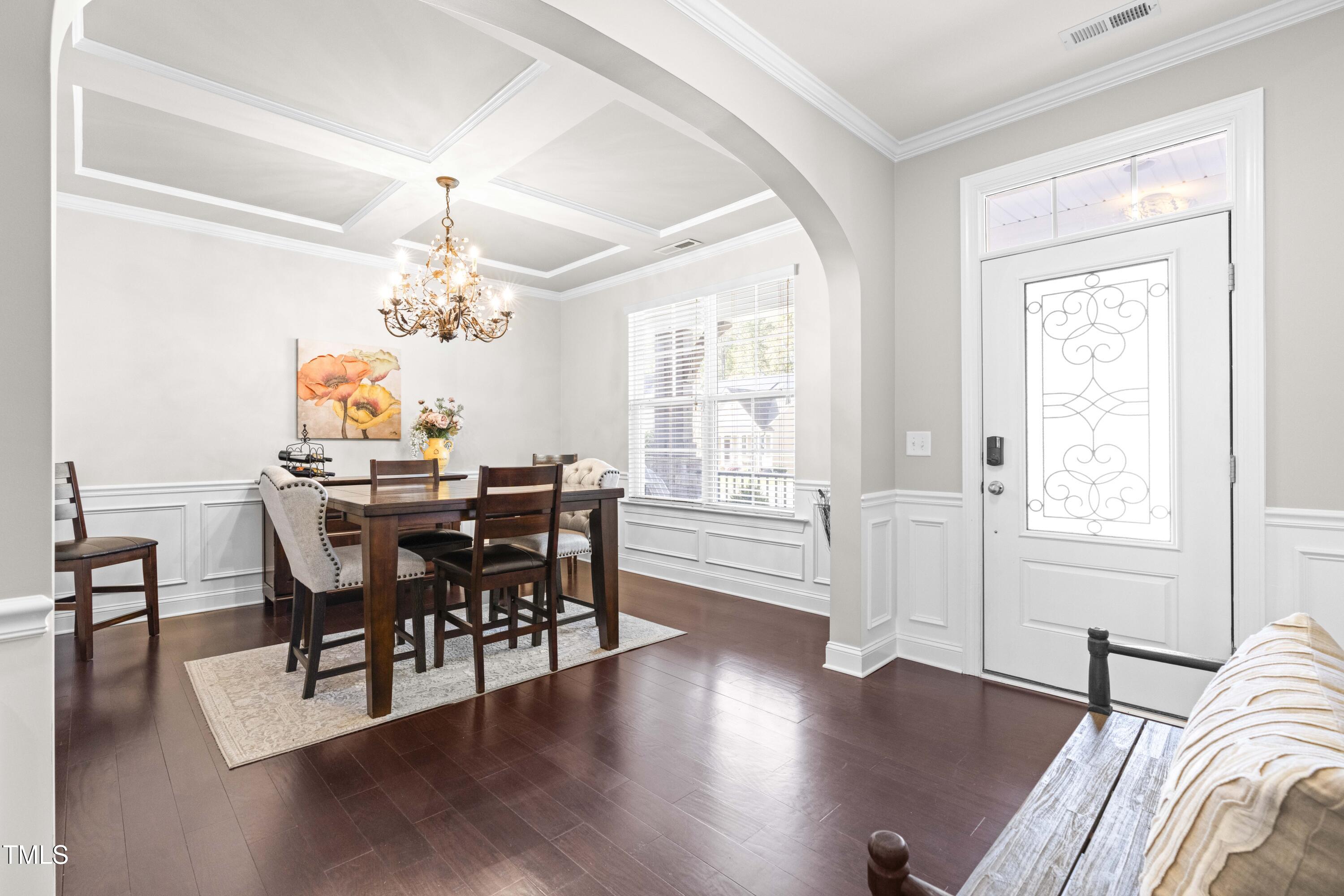 1805 Bodwin Lane Apex, NC 27502 - Photo 4 of 43 a view of a dining room with furniture wooden floor and chandelier