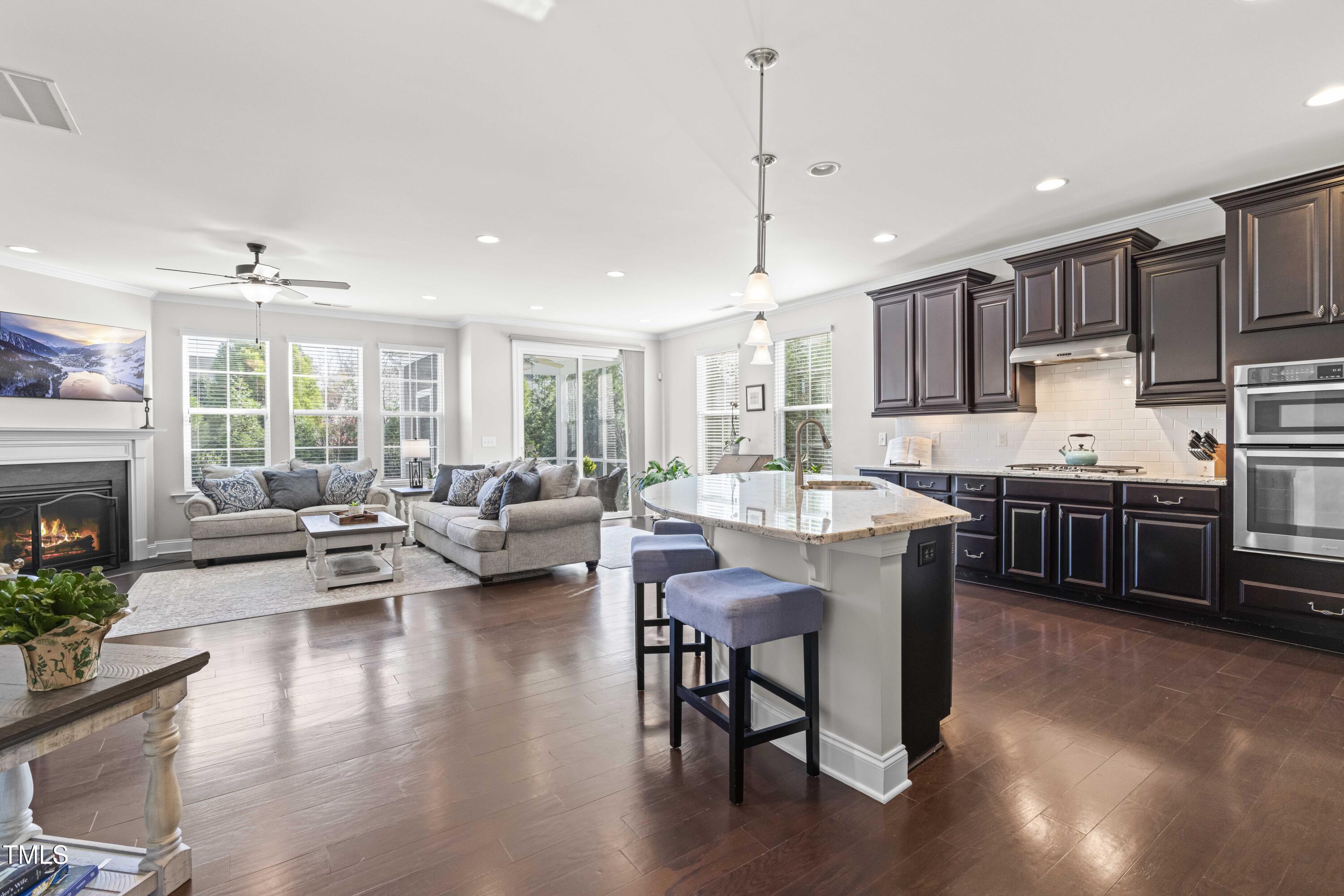 1805 Bodwin Lane Apex, NC 27502 - Photo 10 of 43 a open kitchen with stainless steel appliances granite countertop a stove dining table and chairs