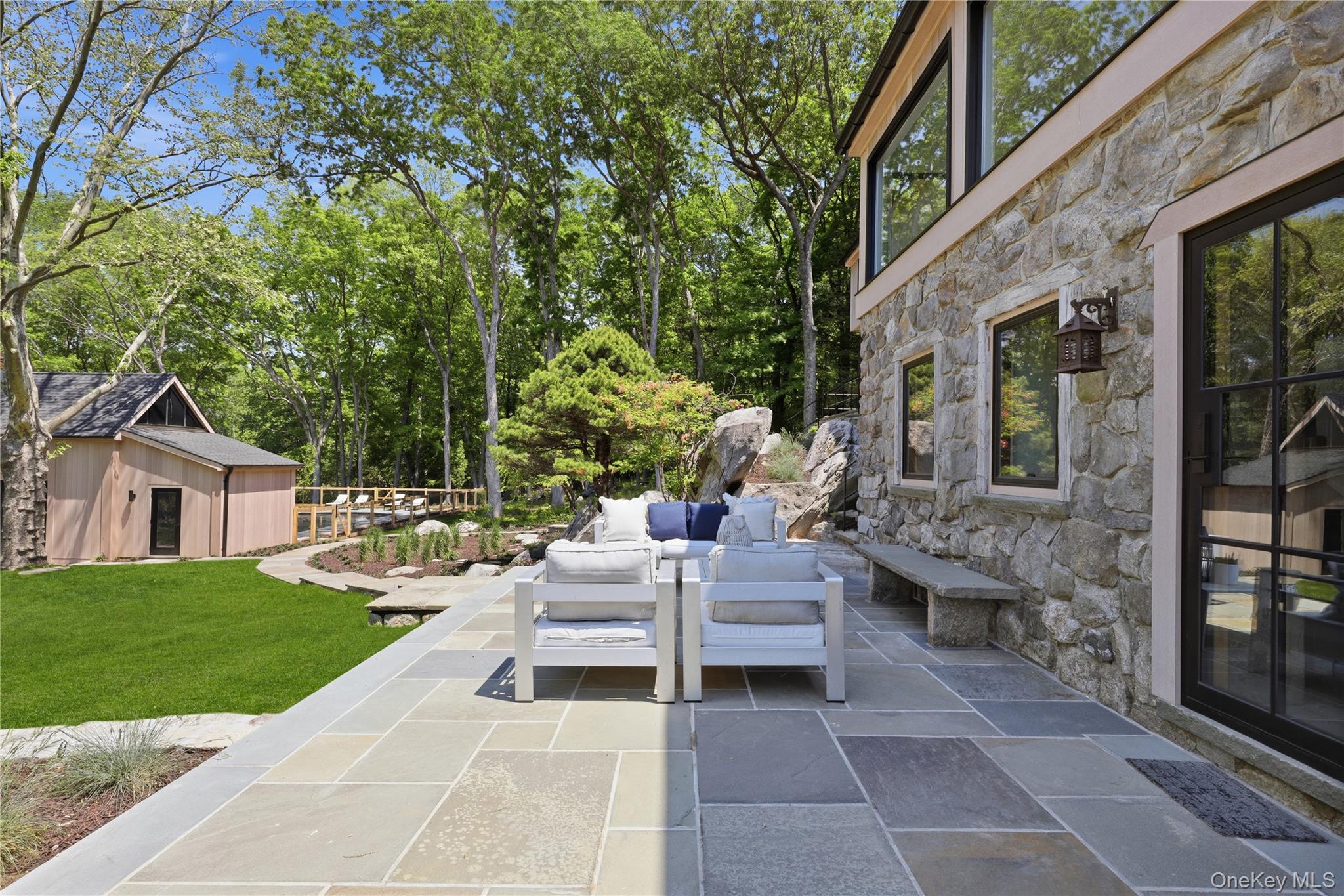 39 Old Snake Hill Road Pound Ridge, NY 10576 - Photo 33 of 37 a view of house with patio outdoor seating and entertaining space