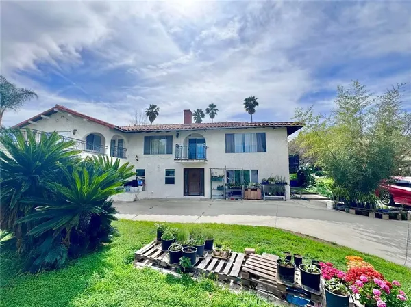 a front view of house with yard and outdoor seating