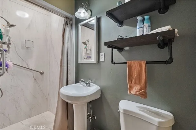 a bathroom with a toilet sink and mirror