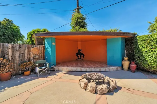 a backyard of a house with table and chairs