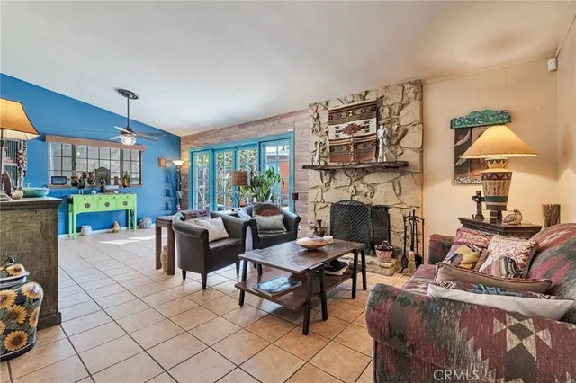 a living room with furniture a fireplace and a table