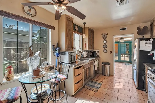 a open kitchen with stainless steel appliances kitchen island granite countertop a sink and cabinets