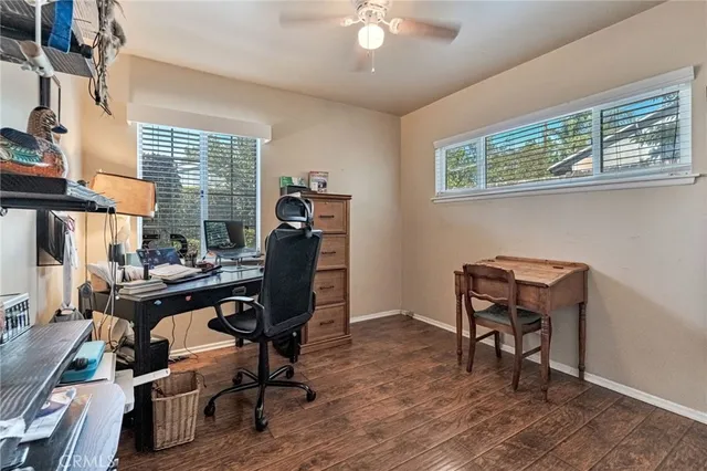 a view of a workspace with furniture and a window