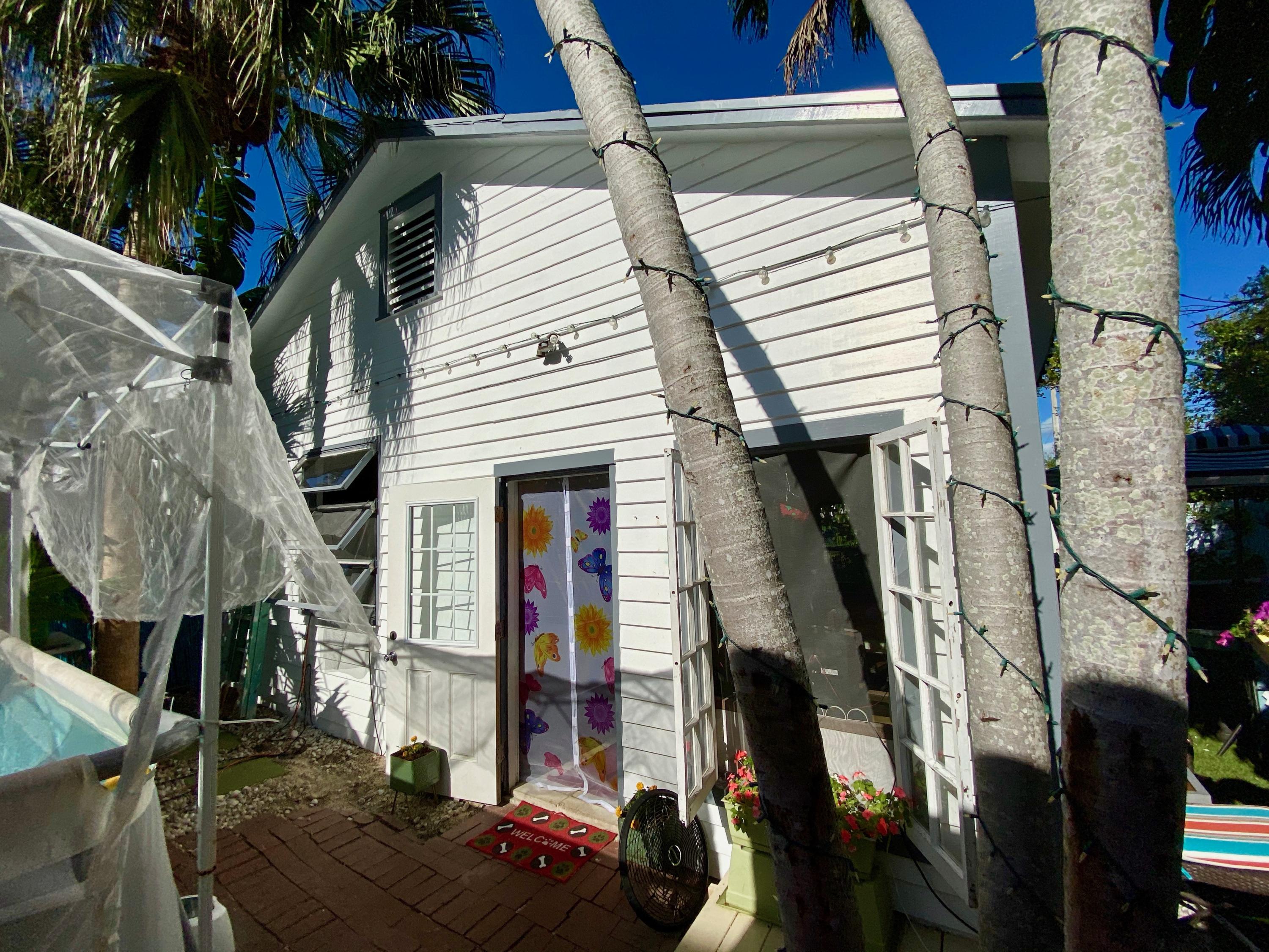 1438 Virginia Street Key West, FL 33040 - Photo 20 of 37 a view of entryway with wooden stairs