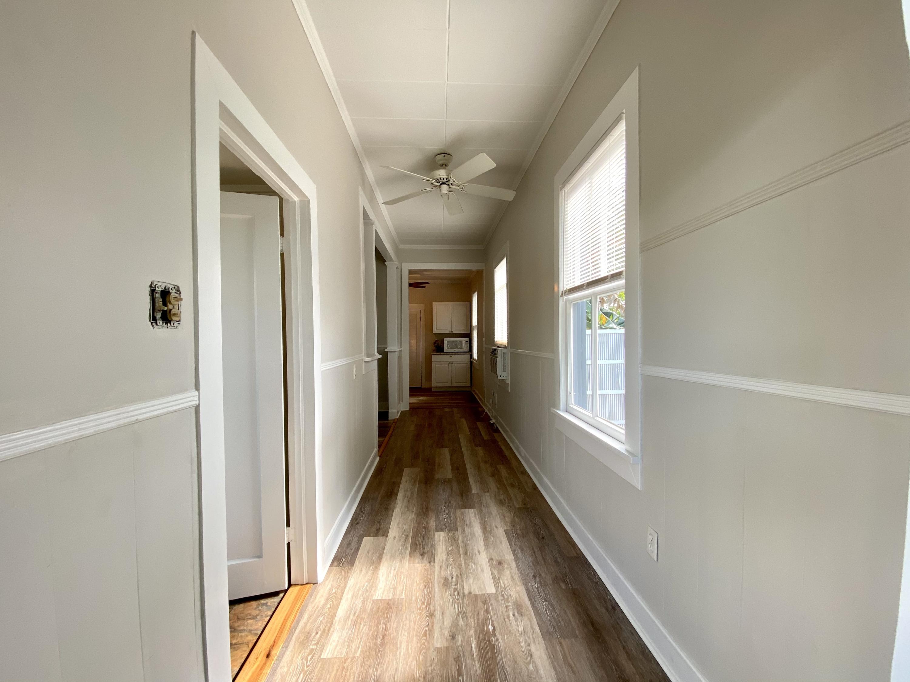 1438 Virginia Street Key West, FL 33040 - Photo 3 of 37 a view of a hallway with wooden floor and staircase