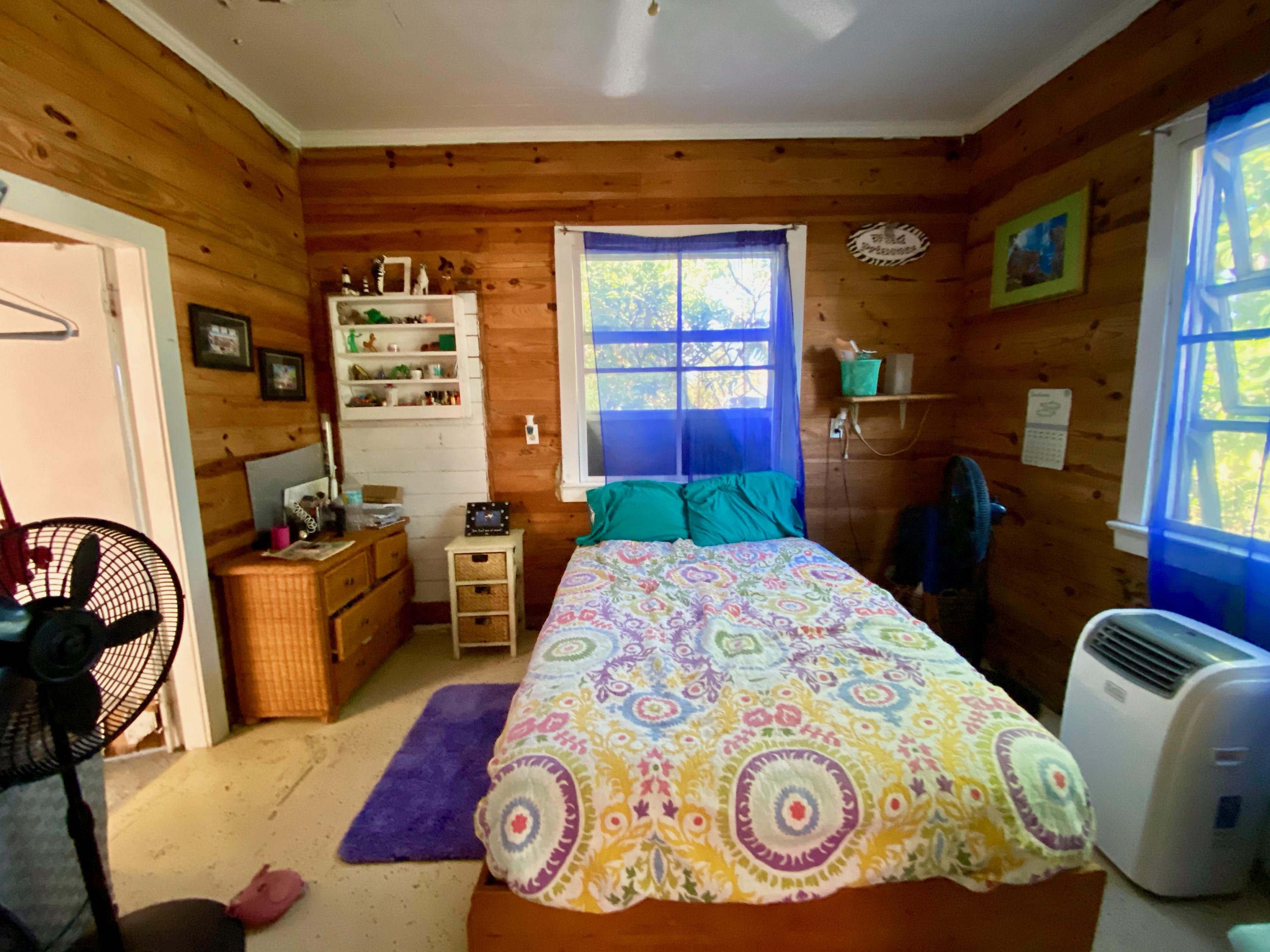 1438 Virginia Street Key West, FL 33040 - Photo 23 of 37 a bedroom with a bed and dresser with mirror