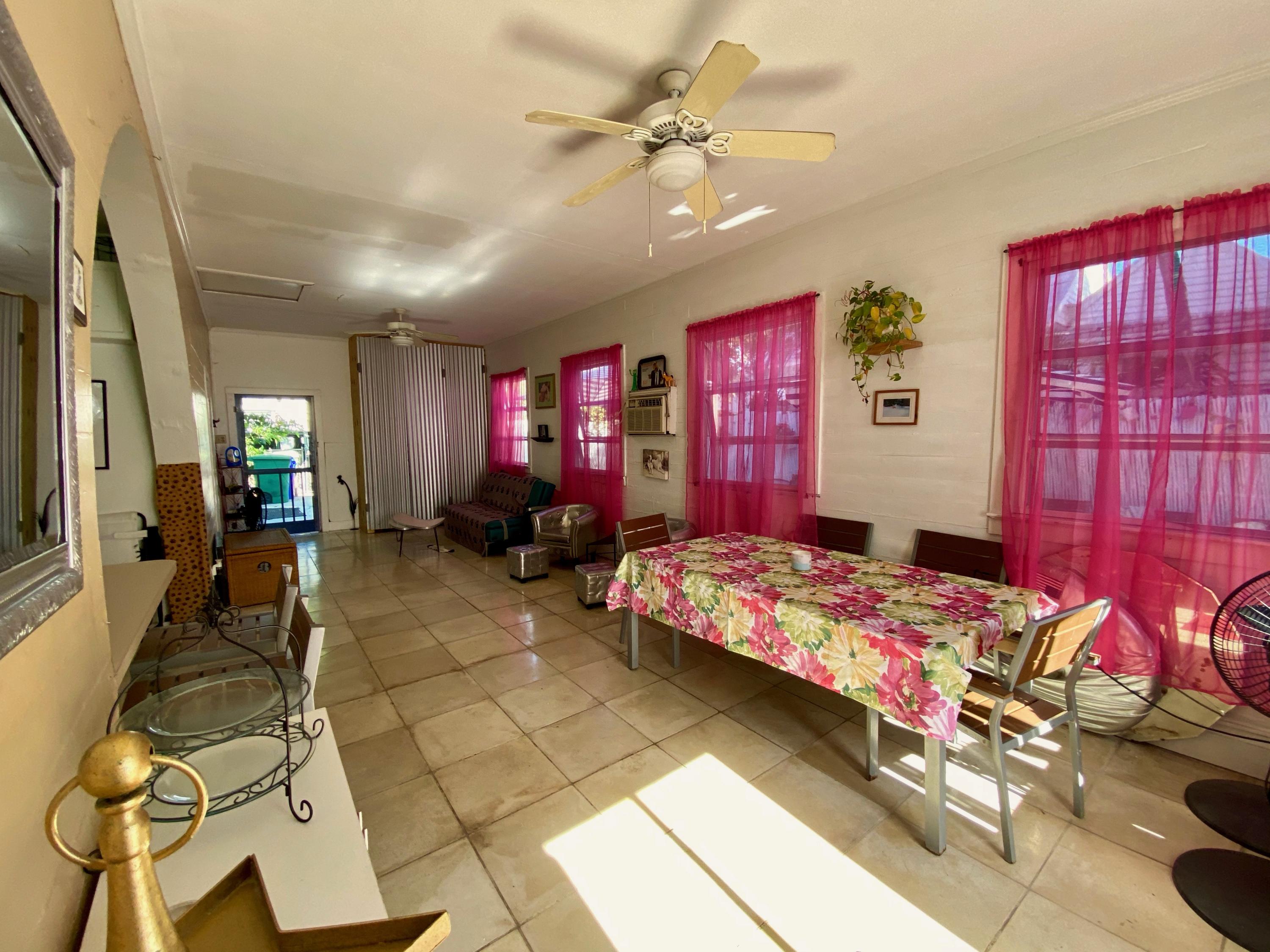 1438 Virginia Street Key West, FL 33040 - Photo 24 of 37 a bedroom with furniture and windows