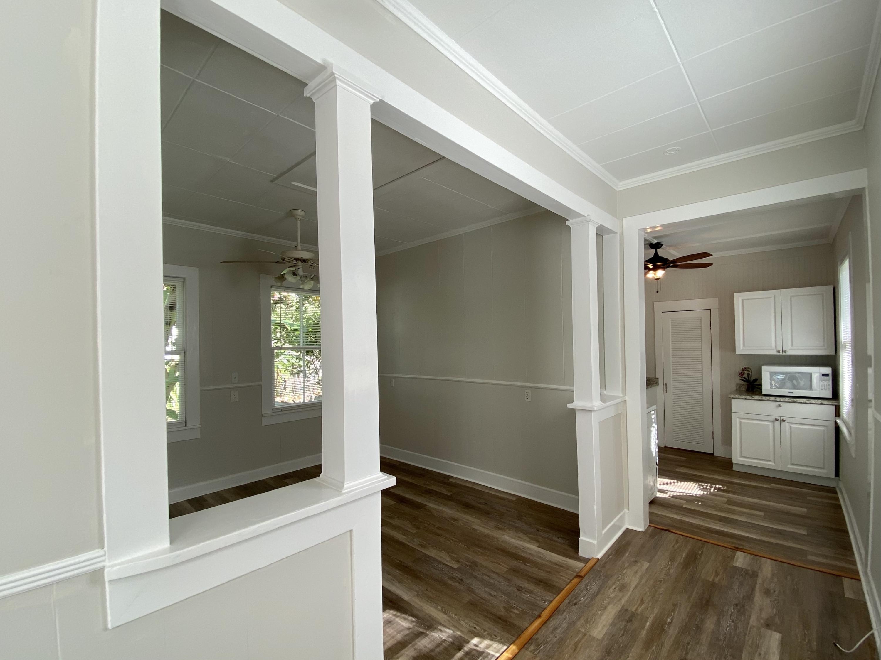 1438 Virginia Street Key West, FL 33040 - Photo 5 of 37 a view of a kitchen from the hallway with a sink and a living room