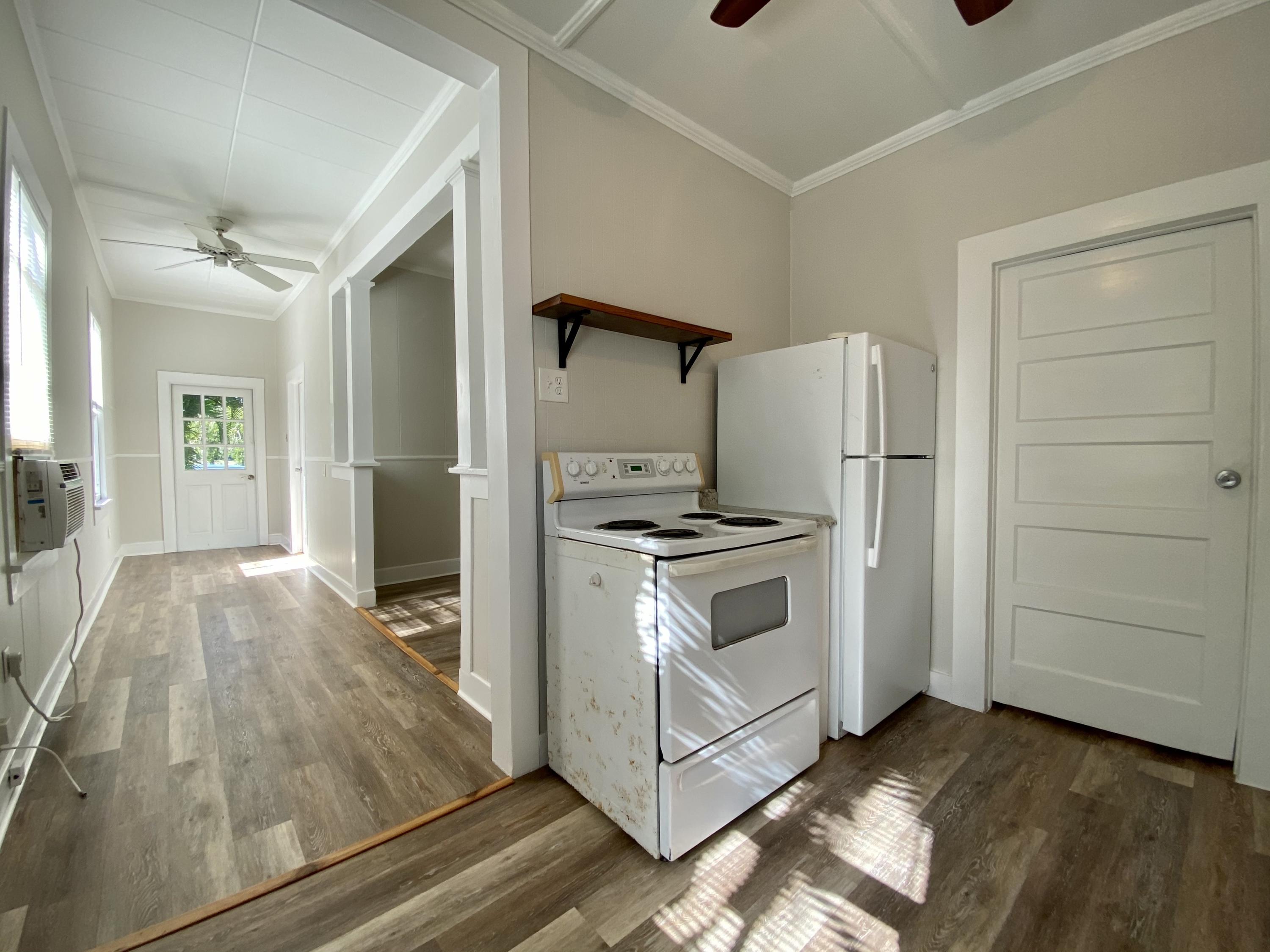 1438 Virginia Street Key West, FL 33040 - Photo 8 of 37 a kitchen with a stove and a refrigerator