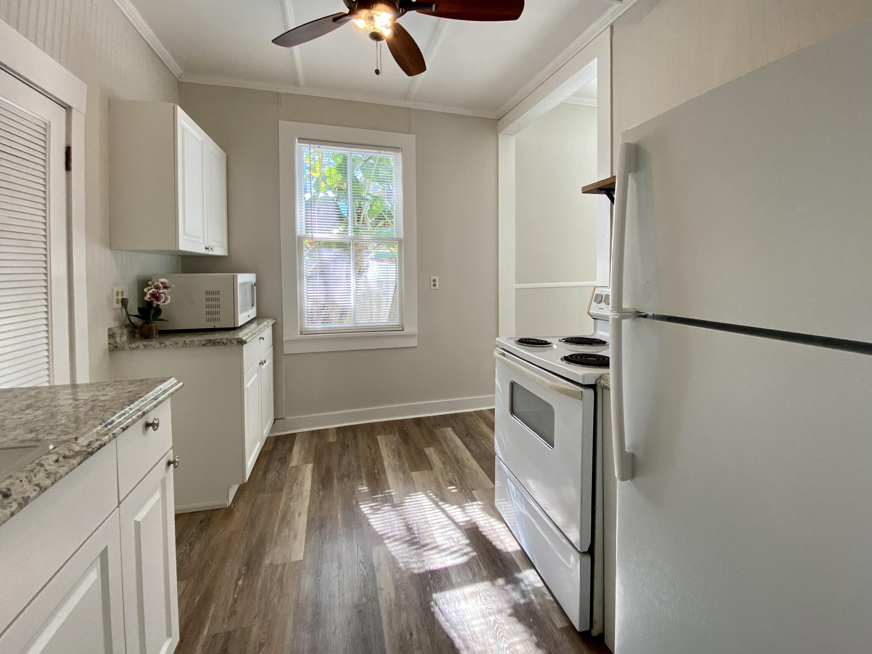 1438 Virginia Street Key West, FL 33040 - Photo 9 of 37 a kitchen with a sink appliances cabinets and a window