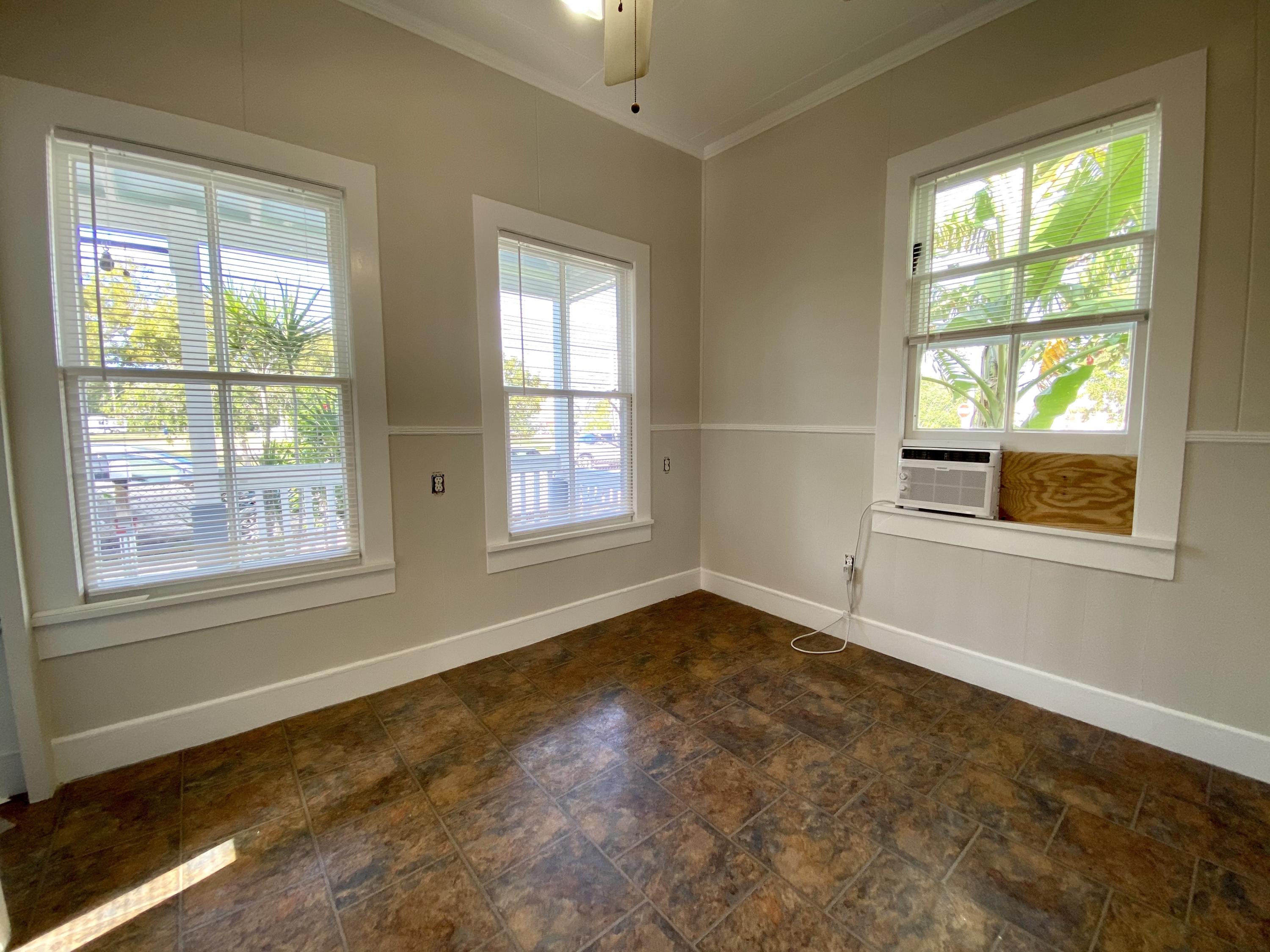 1438 Virginia Street Key West, FL 33040 - Photo 10 of 37 a view of an empty room with a window
