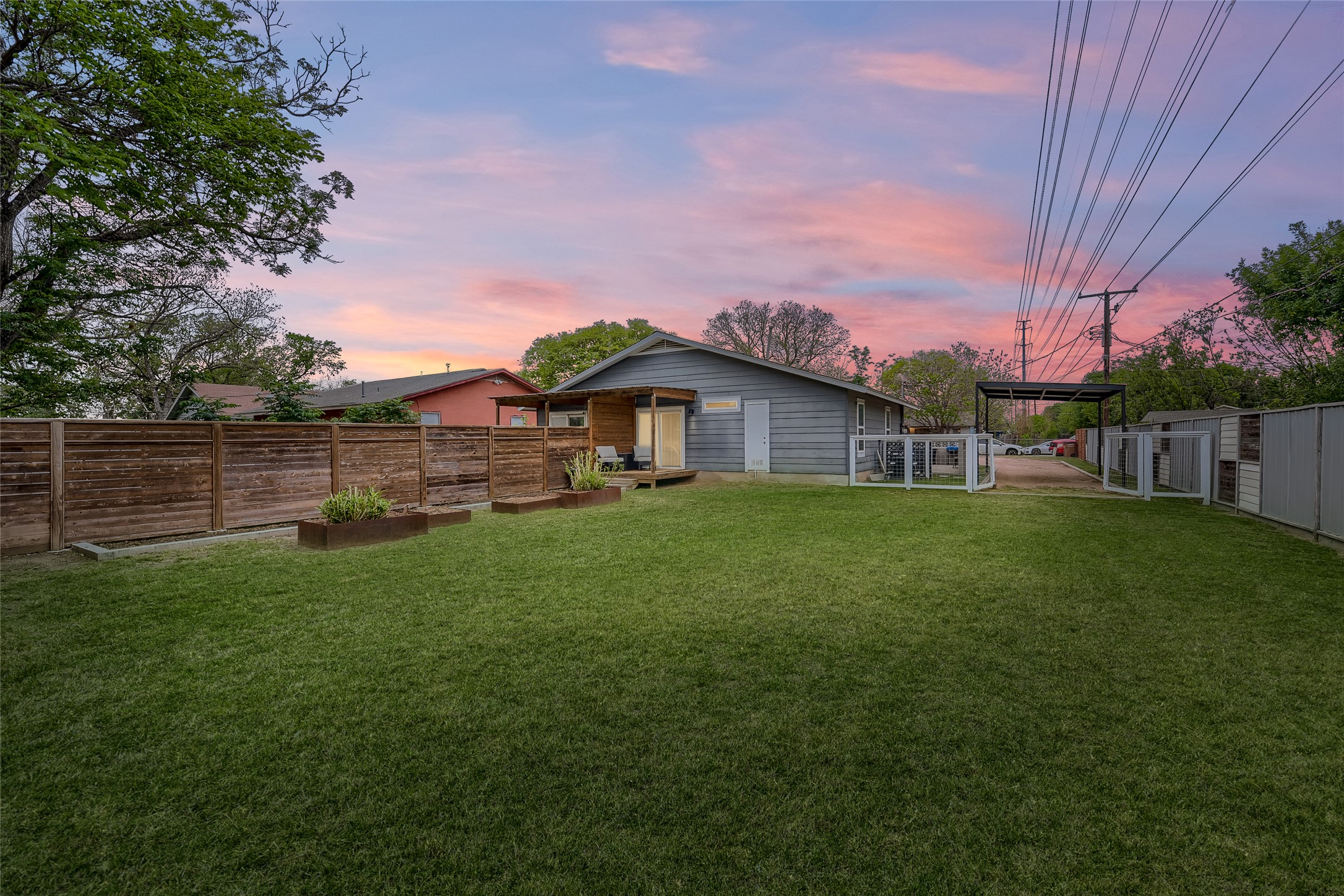 5707 Tracy Lynn Lane, Unit A Austin, TX 78721 - Photo 31 of 33 Back of property at dusk with an outbuilding