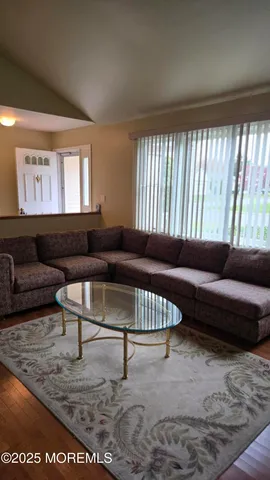 a living room with furniture and a rug