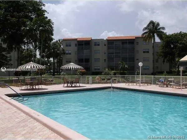 a view of a swimming pool and a yard in the back
