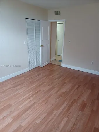 a view of an empty room and wooden floor
