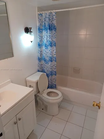 a bathroom with a toilet a sink and bathtub