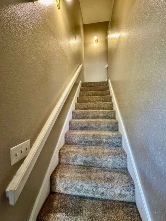 1305 West Villa Maria Road, Unit F105 Bryan, TX 77801 - Photo 11 of 26 Stairs featuring a textured wall