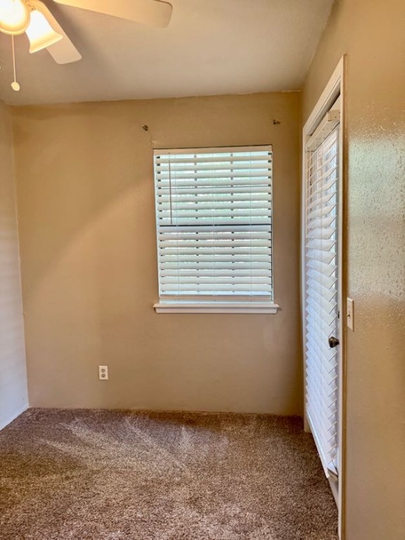 1305 West Villa Maria Road, Unit F105 Bryan, TX 77801 - Photo 17 of 26 Unfurnished bedroom with carpet flooring and a ceiling fan