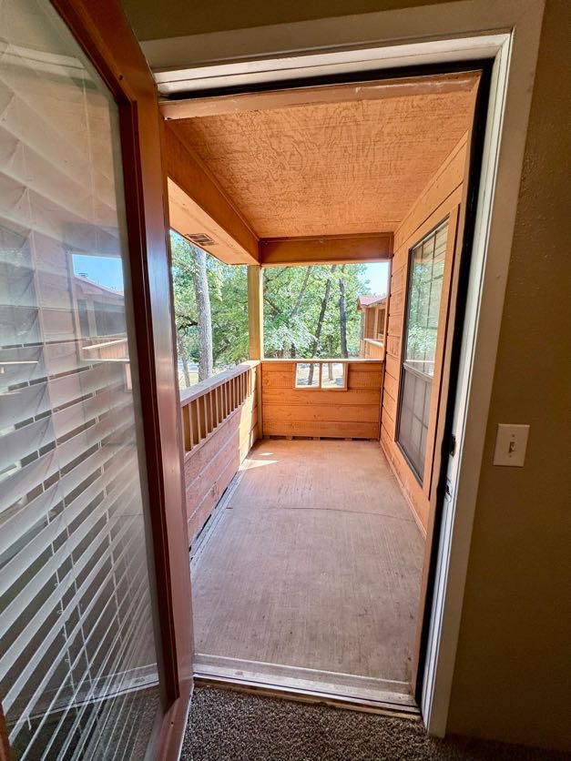 1305 West Villa Maria Road, Unit F105 Bryan, TX 77801 - Photo 24 of 26 a view of a porch with wooden floor and a porch