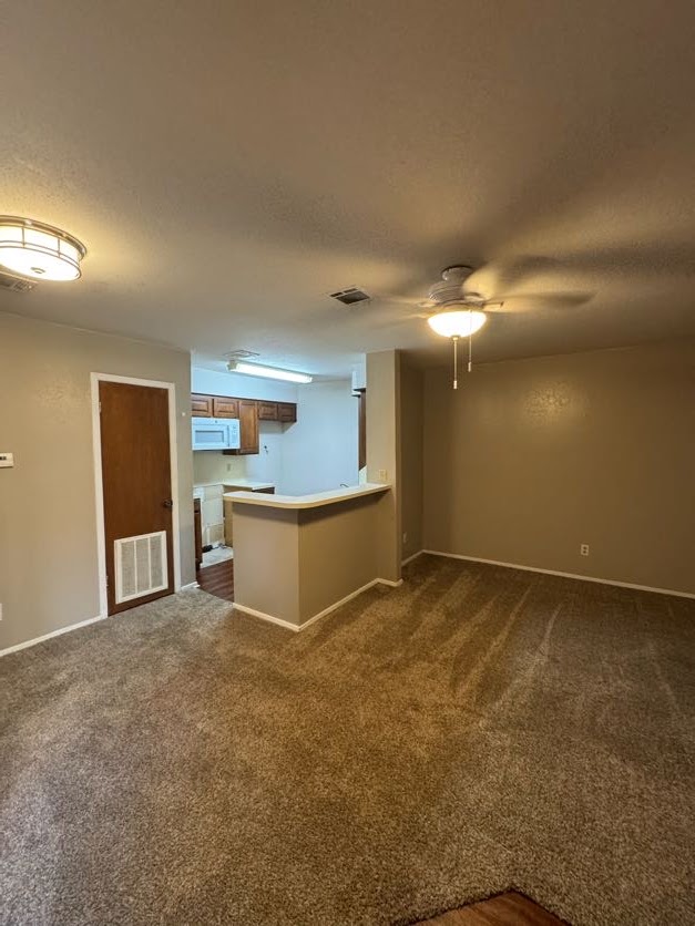 1305 West Villa Maria Road, Unit F105 Bryan, TX 77801 - Photo 6 of 26 a view of an empty room with kitchen