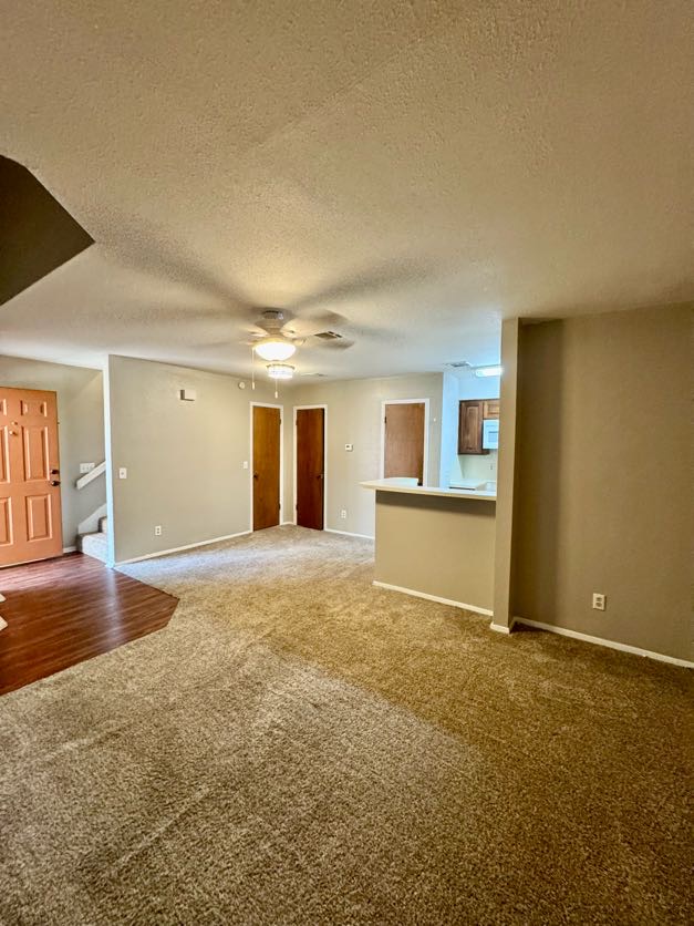 1305 West Villa Maria Road, Unit F105 Bryan, TX 77801 - Photo 8 of 26 a view of an empty room with a kitchen