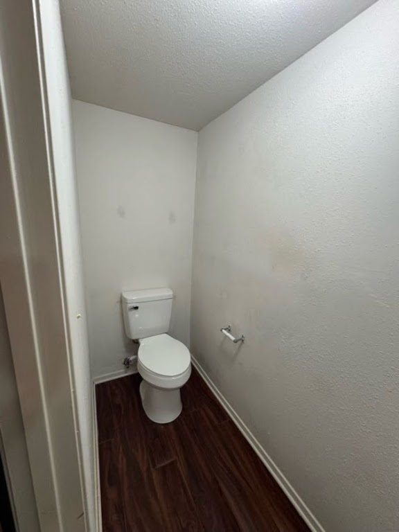 1305 West Villa Maria Road, Unit F105 Bryan, TX 77801 - Photo 9 of 26 Bathroom with dark wood finished floors and a textured ceiling