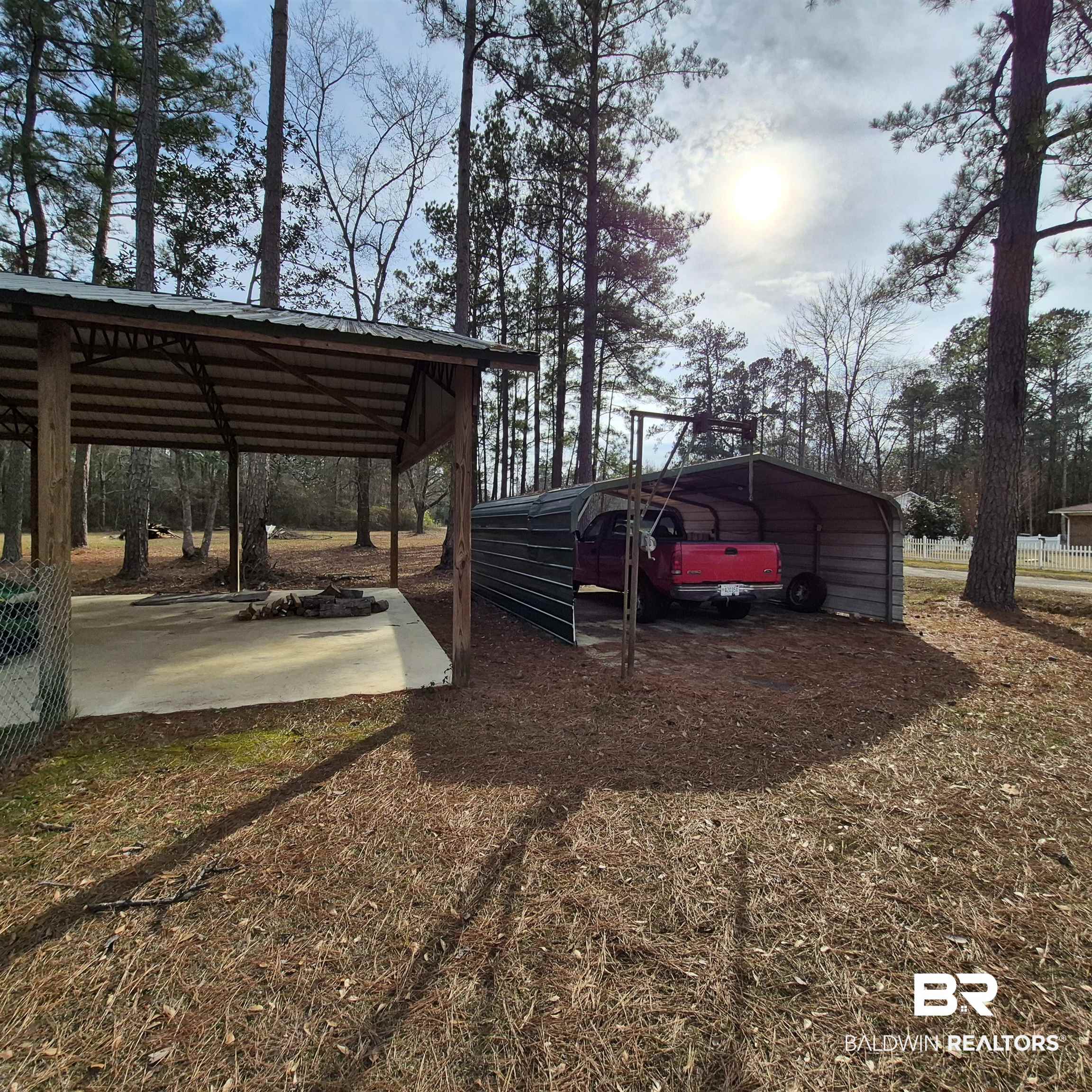 491 Forrest Avenue Castleberry, AL 36432 - Photo 25 of 33 View of parking featuring a detached carport and view of wooded area