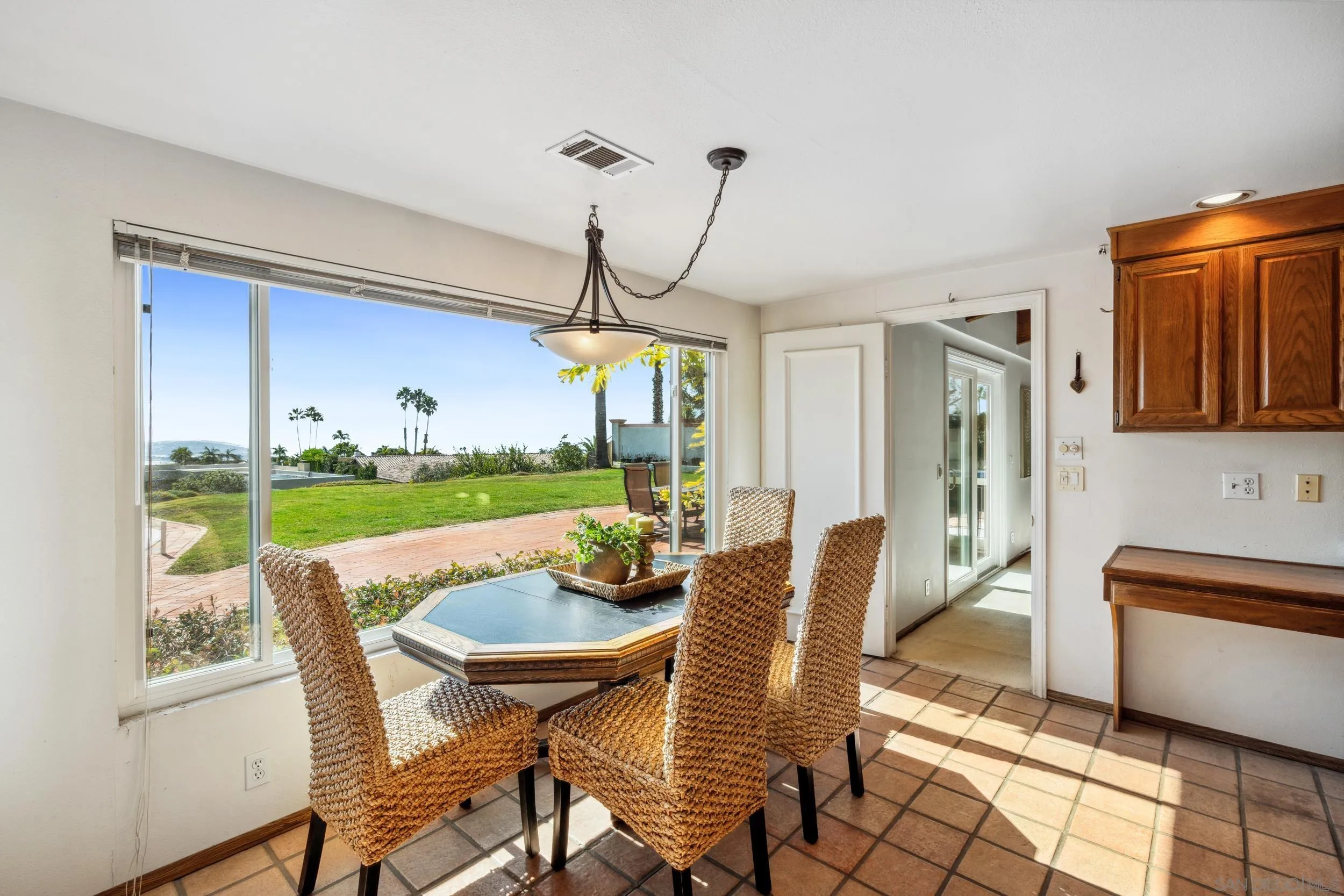 2223 Calle Guaymas La Jolla, CA 92037 - Photo 12 of 32 a view of a dining room with furniture wooden floor and chandelier