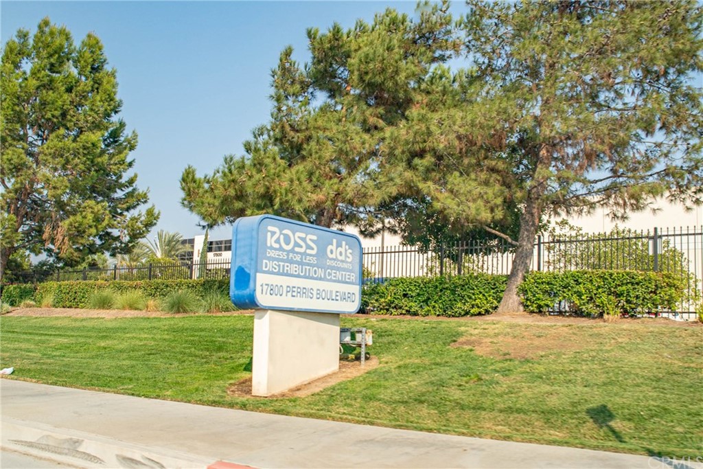 22 Harley Knox Boulevard Perris, CA 92571 - Photo 15 of 35 a sign board with flower garden in front of it