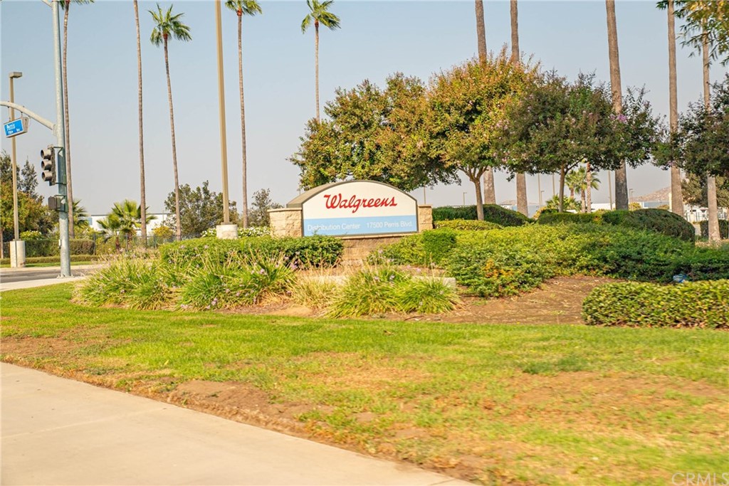 22 Harley Knox Boulevard Perris, CA 92571 - Photo 17 of 35 a view of a swimming pool with a lawn chairs and palm tree