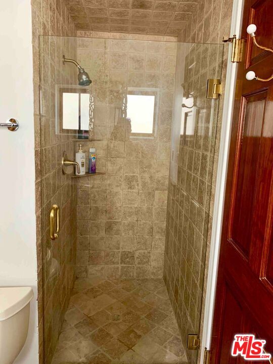 1152 1/2 North Ogden Drive West Hollywood, CA 90046 - Photo 11 of 12 a bathroom with a shower and a toilet