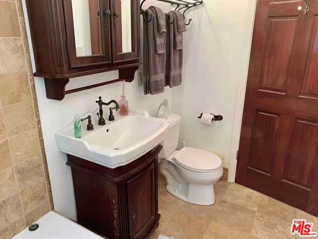 a bathroom with a sink toilet and mirror