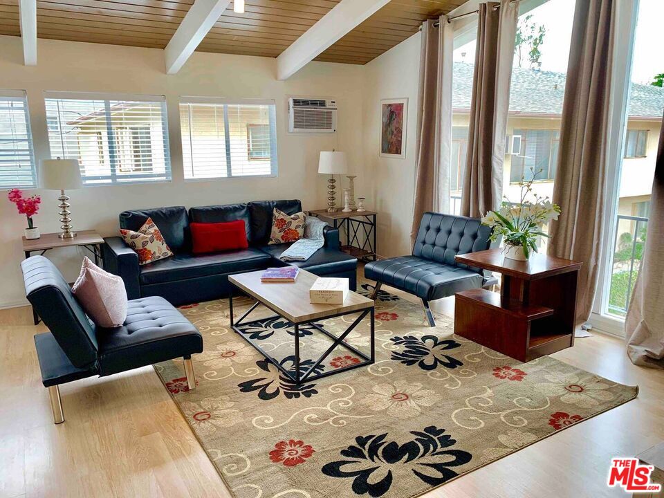 1152 1/2 North Ogden Drive West Hollywood, CA 90046 - Photo 2 of 12 a living room with furniture and wooden floor