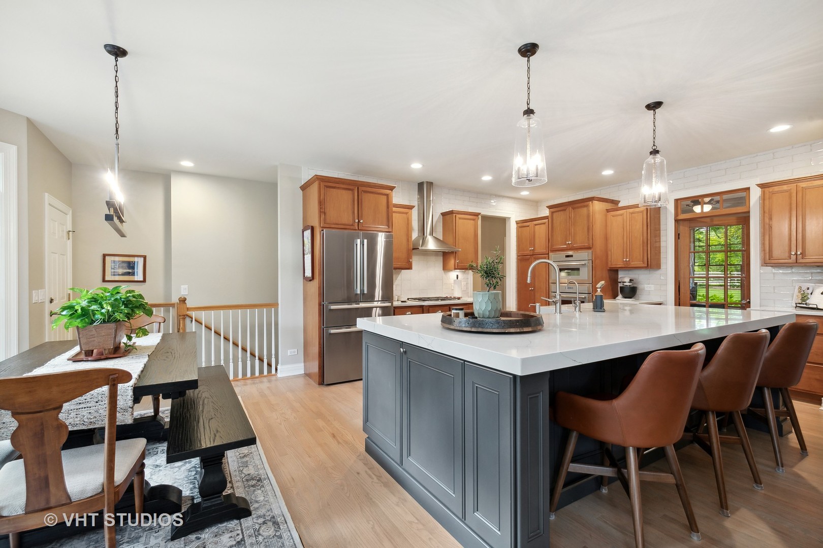 8902 Voss Road Marengo, IL 60152 - Photo 14 of 35 a kitchen with kitchen island a dining table chairs stainless steel appliances and cabinets