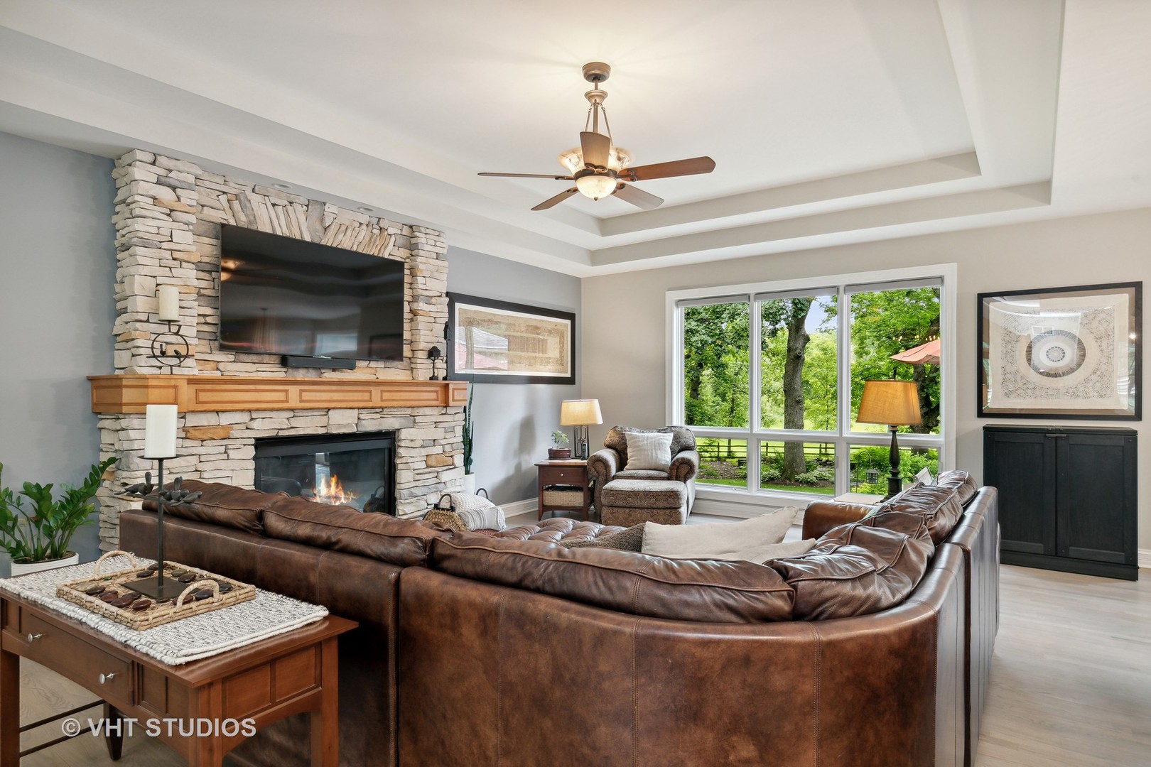 8902 Voss Road Marengo, IL 60152 - Photo 6 of 35 a living room with furniture a fireplace and a flat screen tv