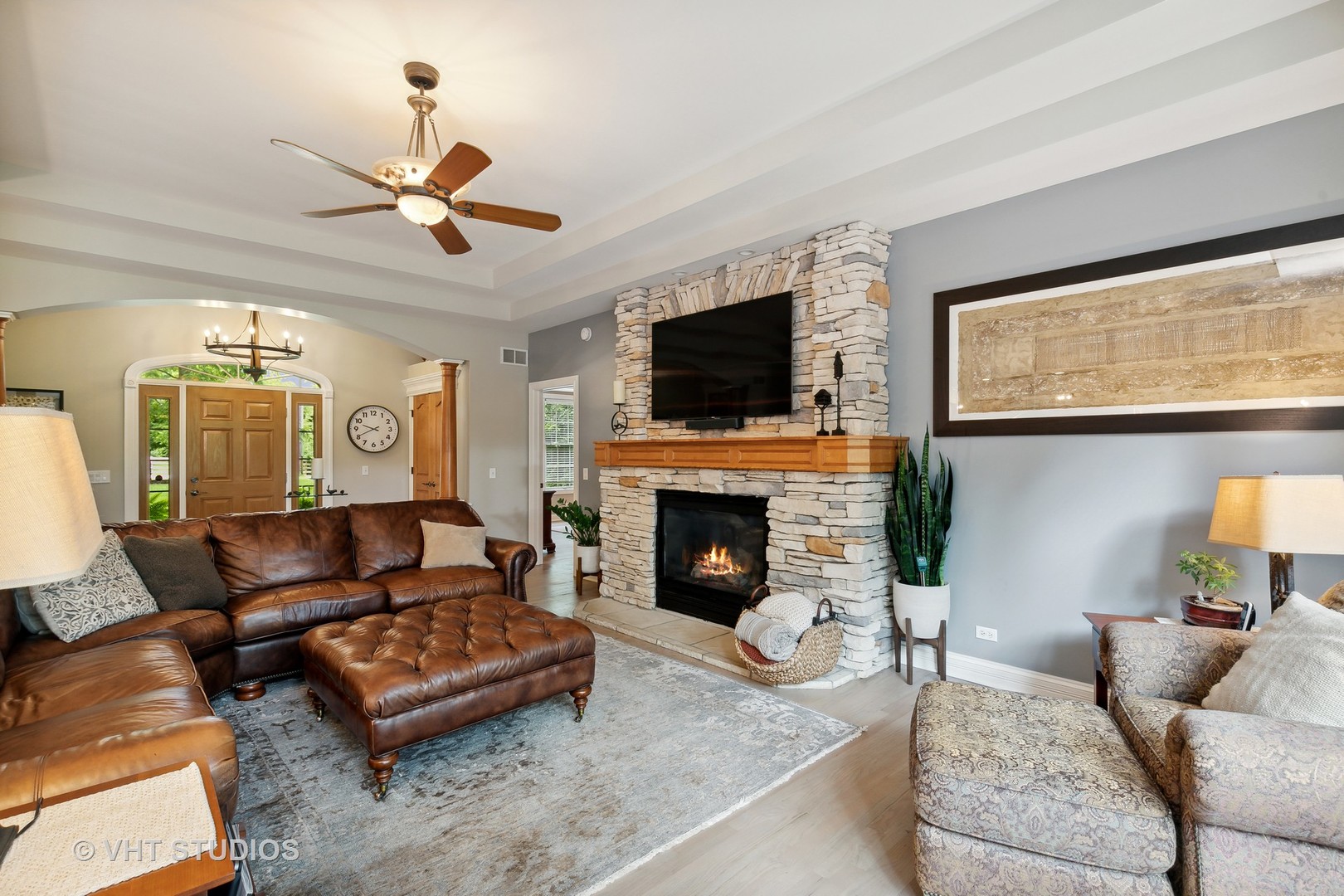 8902 Voss Road Marengo, IL 60152 - Photo 8 of 35 a living room with furniture a fireplace and a flat screen tv
