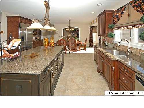 153 Paint Island Spring Road Millstone Township, NJ 08510 - Photo 2 of 3 a kitchen with stainless steel appliances granite countertop a sink dishwasher and cabinets with wooden floor