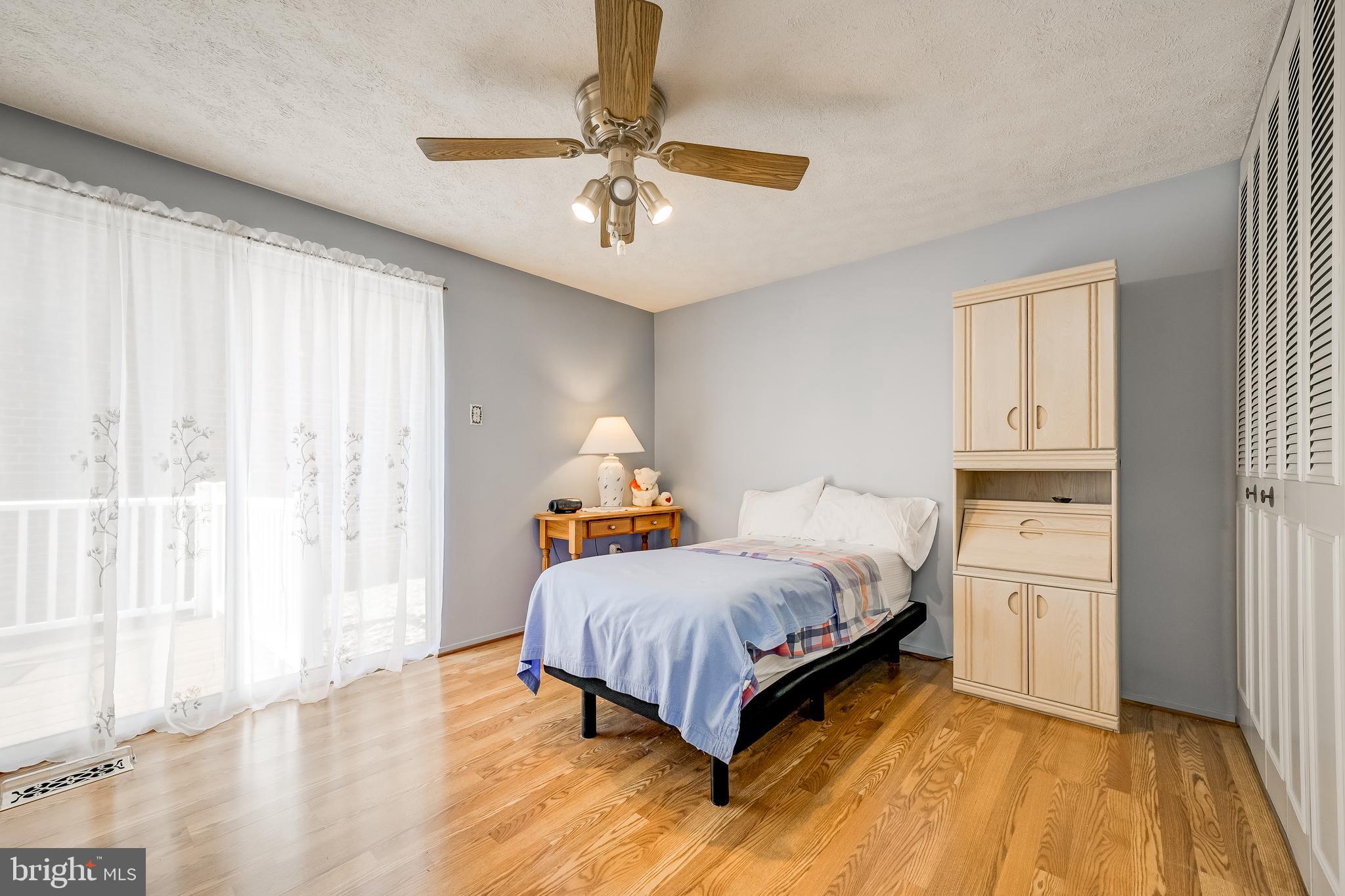 7179 Harp String Columbia, MD 21045 - Photo 12 of 27 a bedroom with a bed and a chandelier
