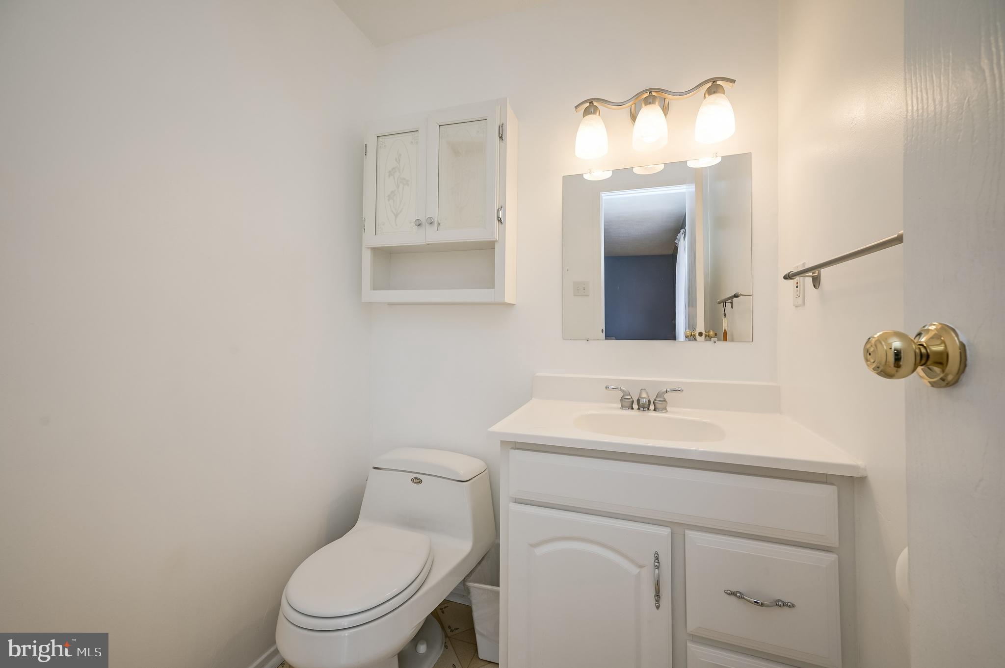 7179 Harp String Columbia, MD 21045 - Photo 15 of 27 a bathroom with a toilet sink vanity and mirror
