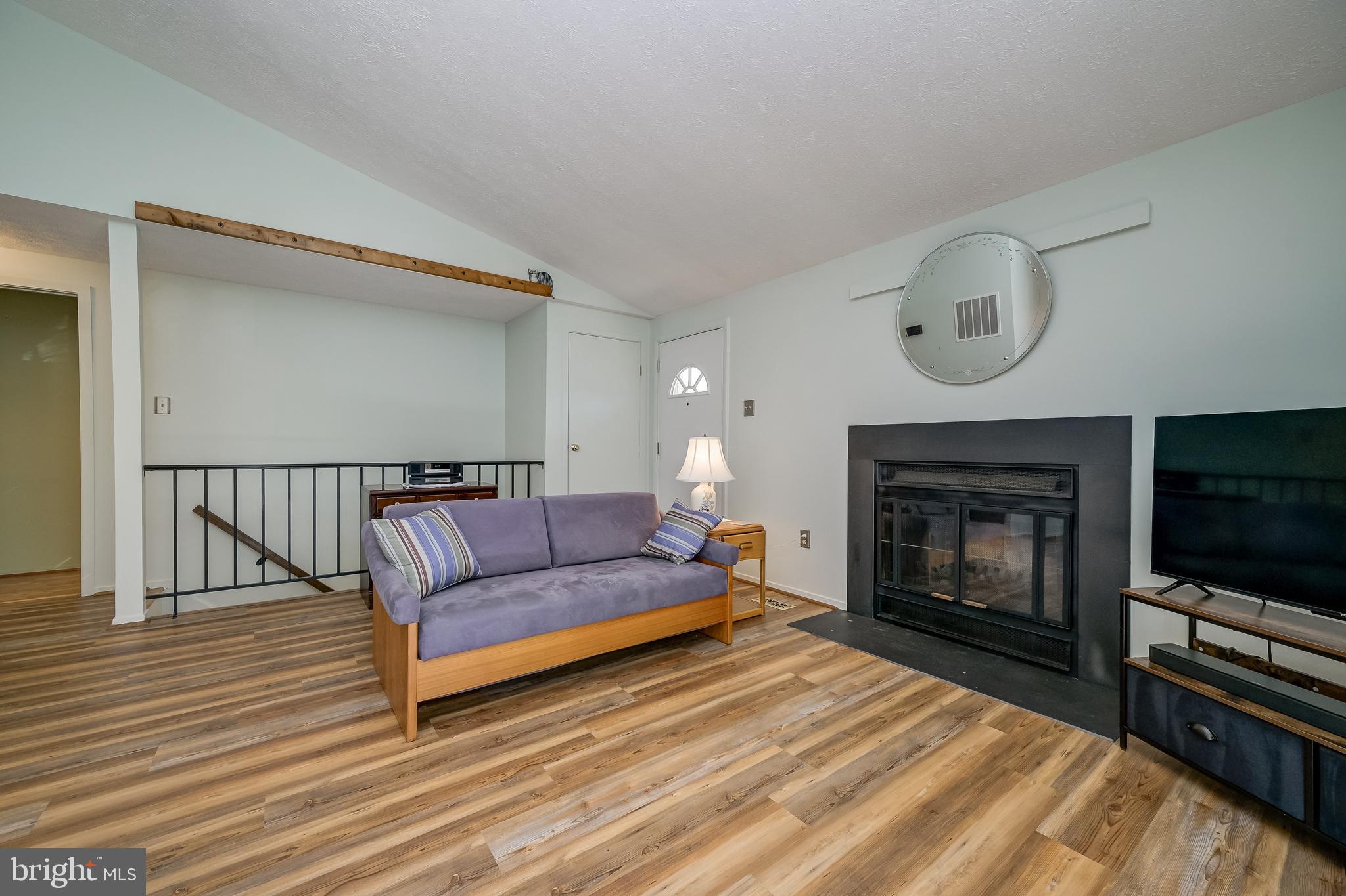 7179 Harp String Columbia, MD 21045 - Photo 7 of 27 a living room with furniture and a fireplace