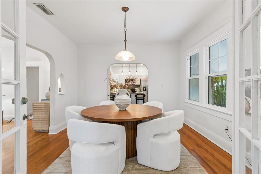 2434 West Prospect Road Tampa, FL 33629 - Photo 8 of 45 a dining room with furniture a chandelier and wooden floor