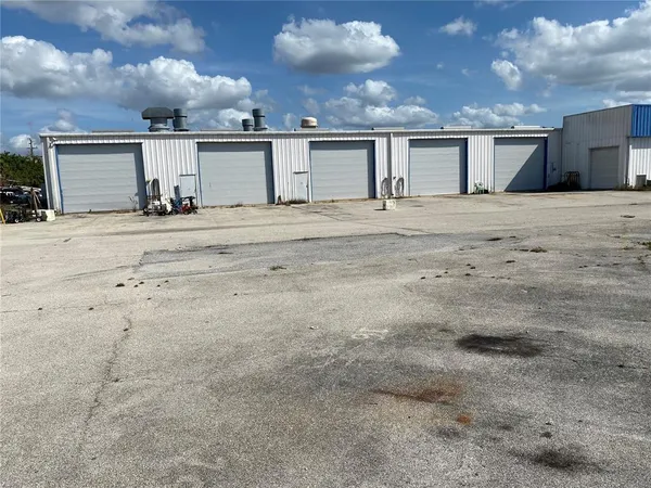 a view of a house with wooden fence