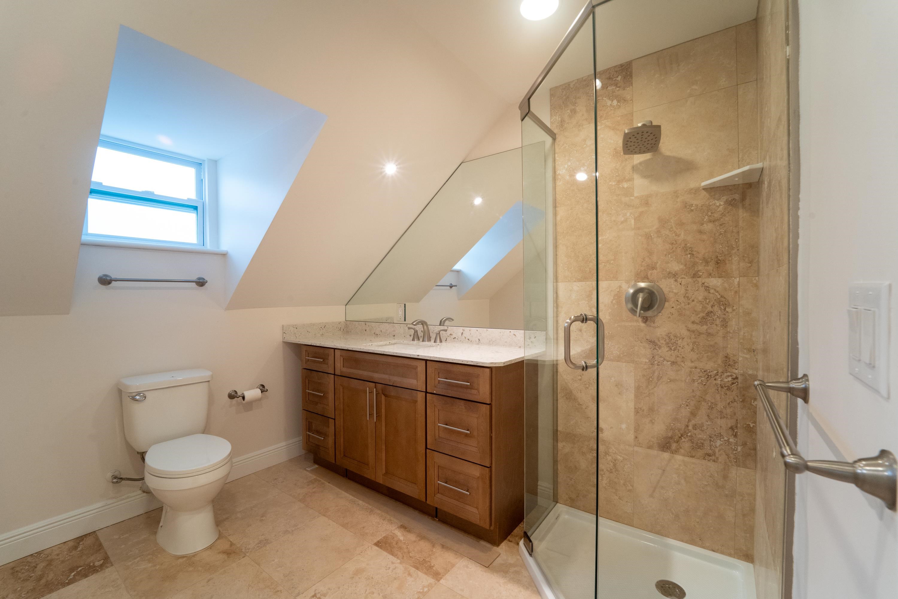 11 Aviles Street, Unit 3C St. Augustine, FL 32084 - Photo 18 of 24 Bathroom with a stall shower and vanity