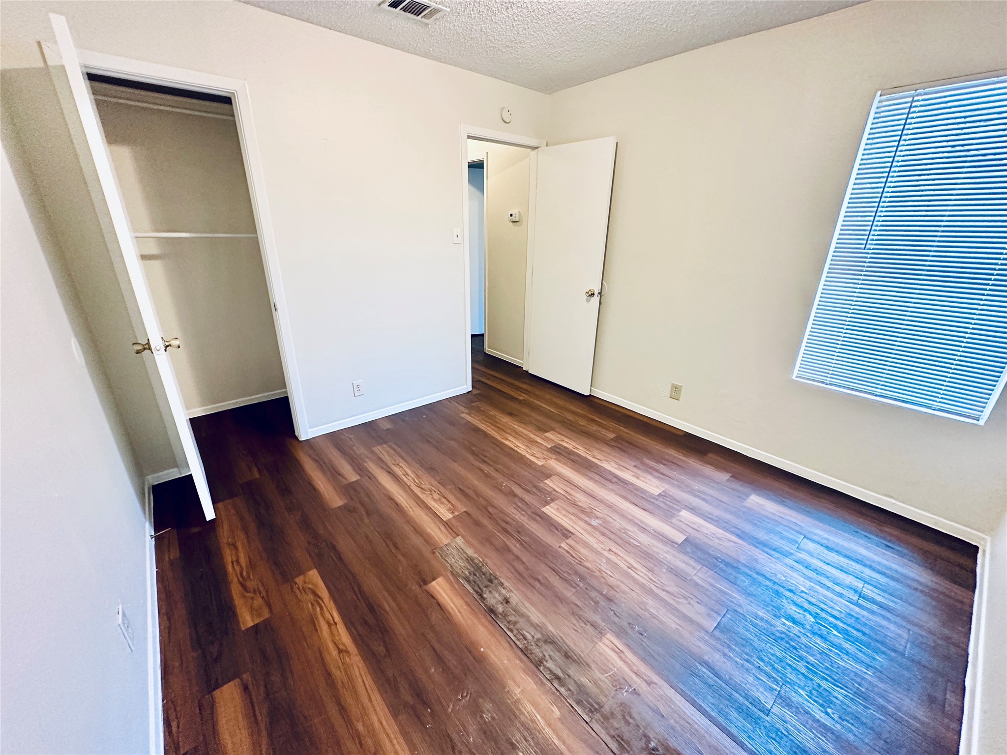 12505 Turtle Rock Road, Unit A Austin, TX 78729 - Photo 31 of 38 Rich hardwood-style flooring extends through this naturally illuminated, versatile space, ready for your personal touch.