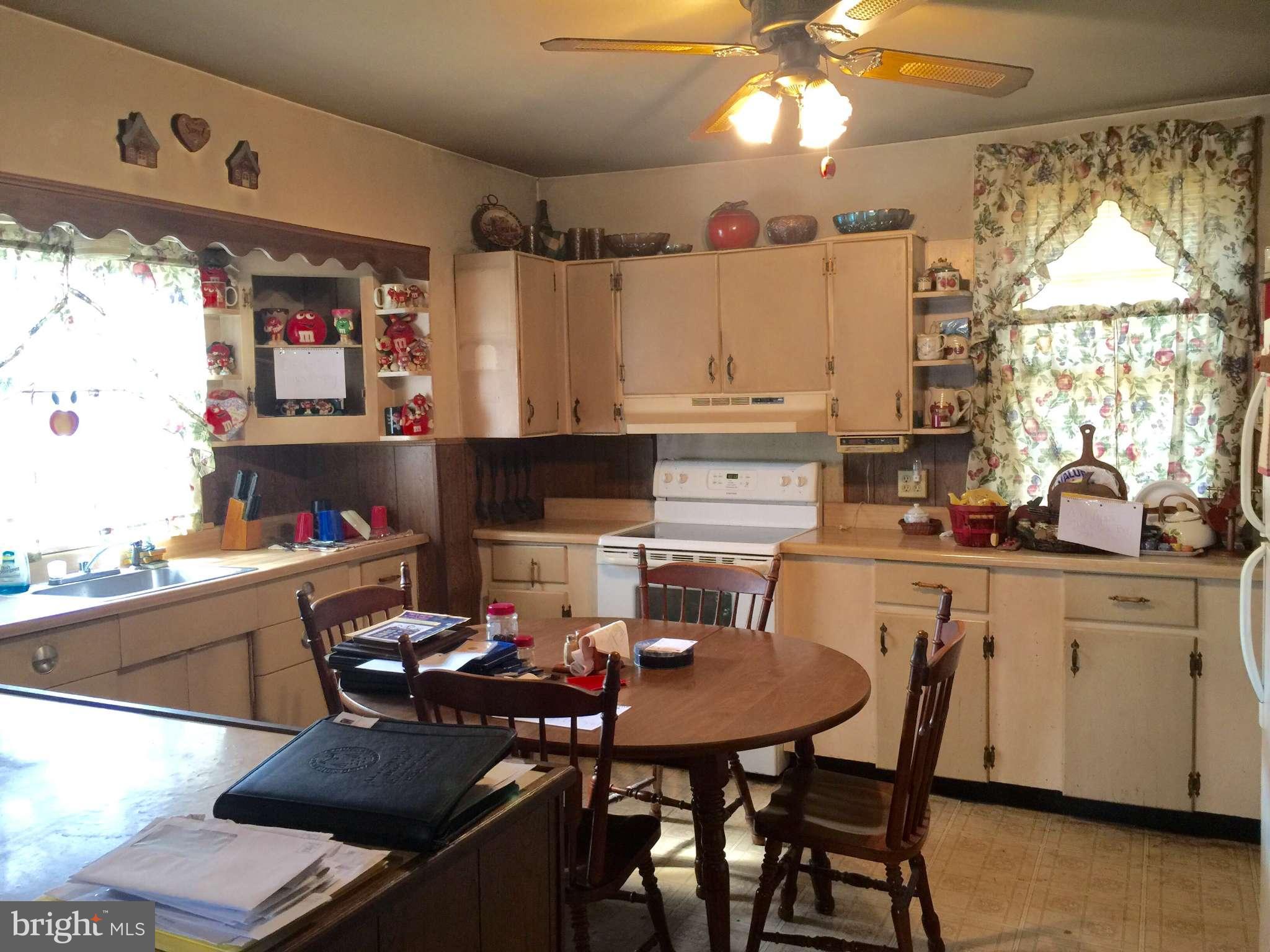 8215 Rocky Ridge Road Thurmont, MD 21788 - Photo 3 of 17 a kitchen with a dining table and chairs
